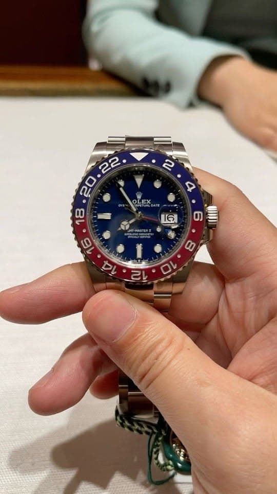 Blue dial blue-red bezel GMT watch in hand